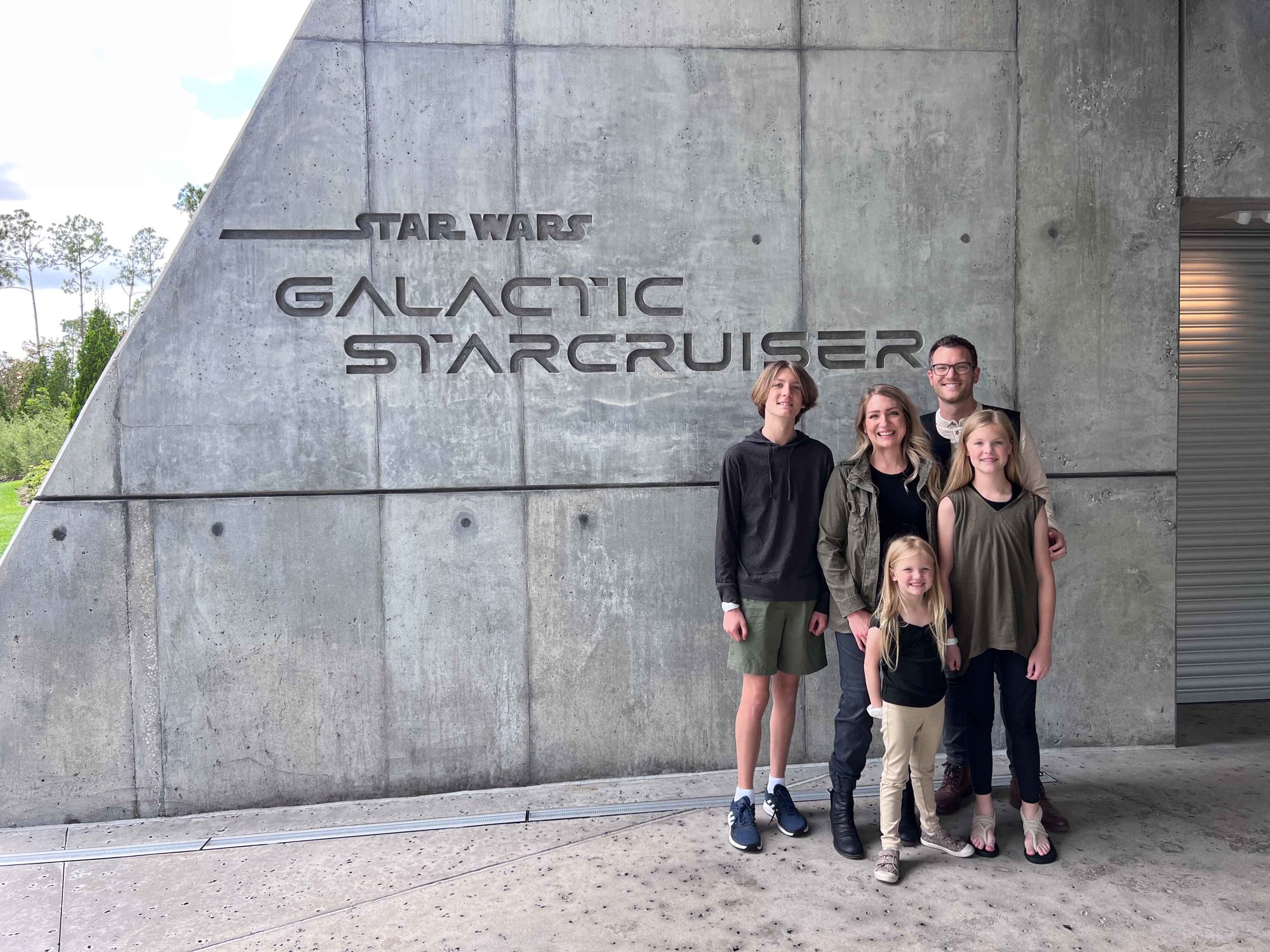 family in front of galactic starcruiser entrance